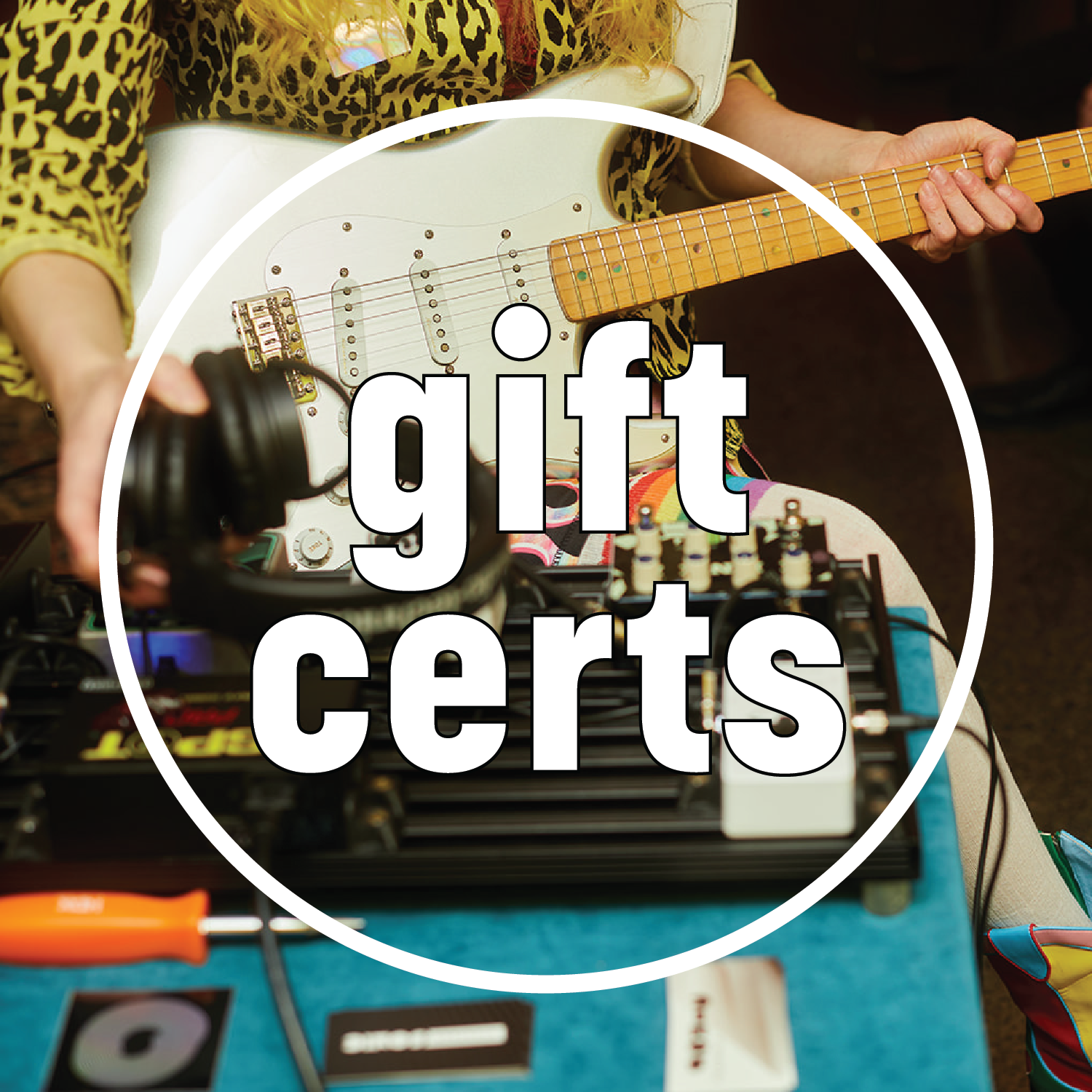 Image shows person holding guitar and reaching for headphones. White circle features white text that reads "gift certs"